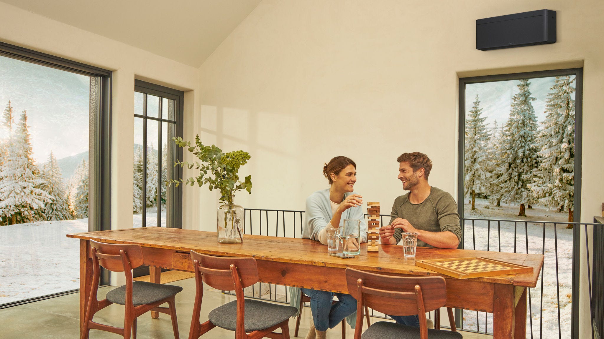 Pár si užíva vykurovanie pomocou klimatizácie v obývacej izbe