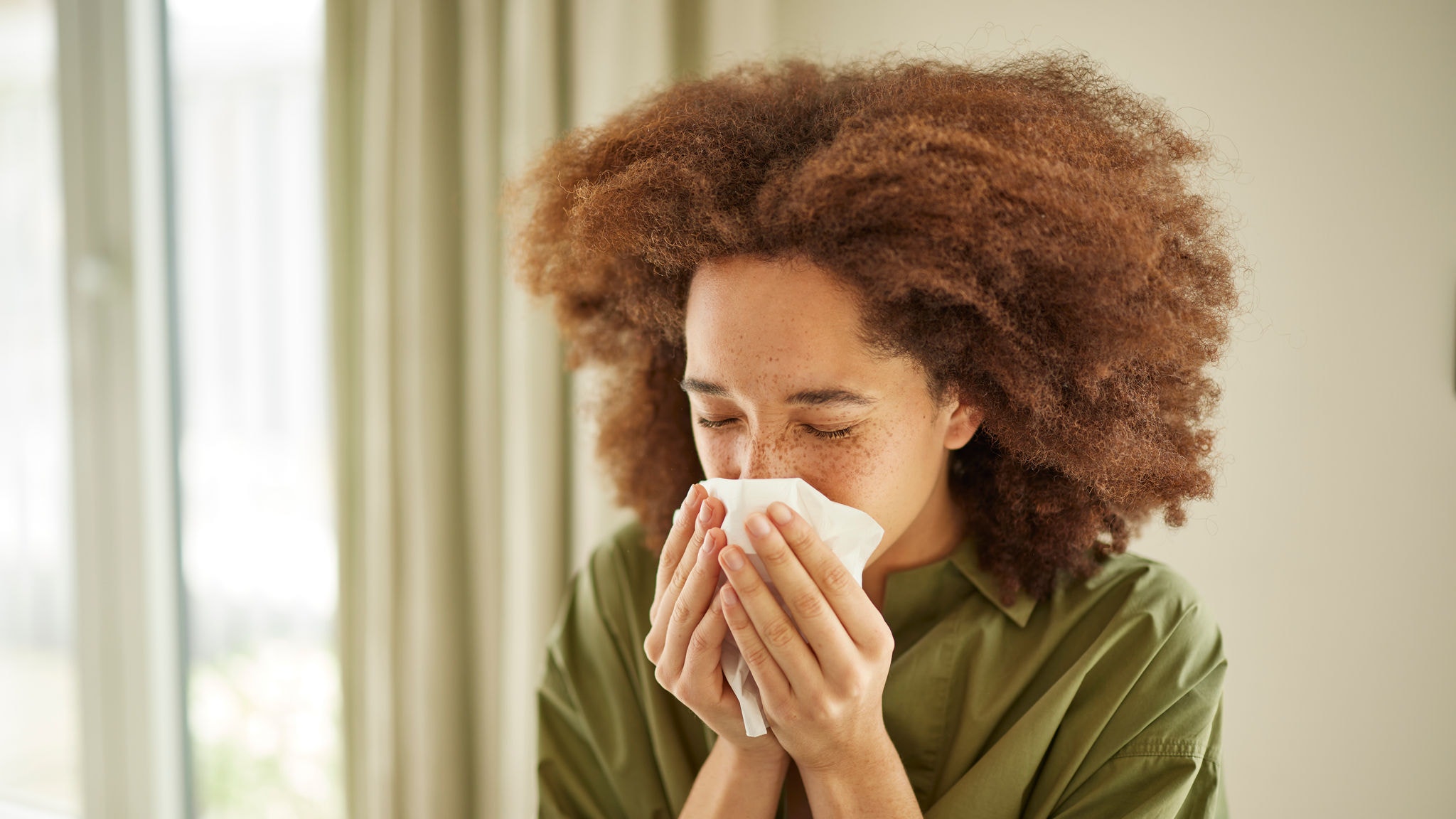 Girl sneezing in need of allergy and flu relief